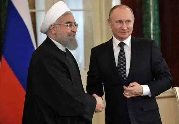 Russian President Putin shakes hands with Iranian President Rouhani during joint news conference following their meeting at Kremlin in Moscow