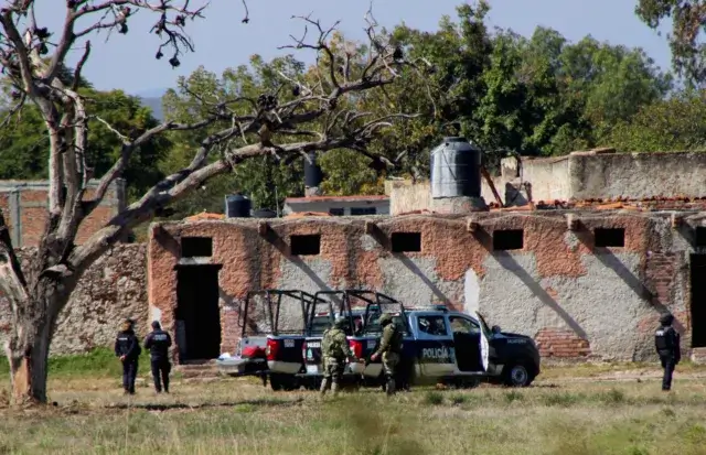 Authorities work at the scene of an attack at a posada, in Salvatierra
